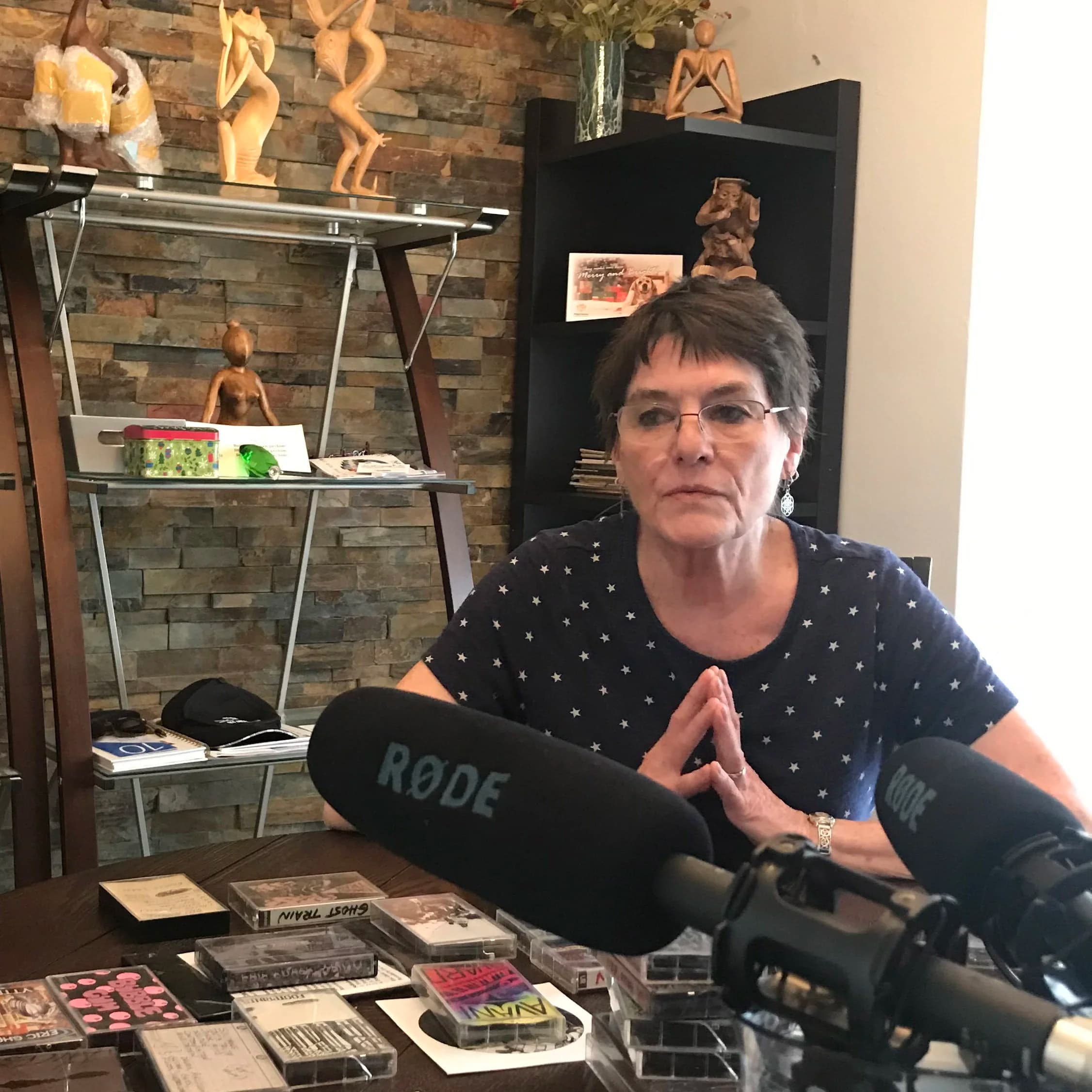 Linda sitting at a table recording an interview with Joshua and Ty